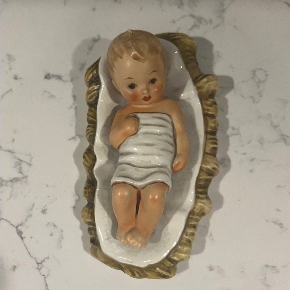 Hummel Baby Jesus in White and Brown bed.